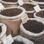 A vibrant display of various coffee beans in sacks at a market in Istanbul.